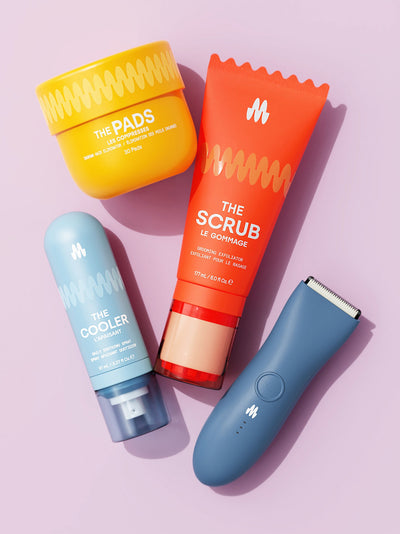 Skincare and grooming products including exfoliating scrub, soothing spray, hair removal pads, and electric trimmer on a pink background.