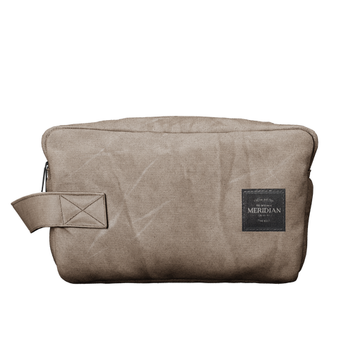 Beige fabric grooming travel pouch with a handle and a black Meridian logo patch.