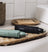Two Meridian branded electric grooming trimmers in black and green, placed on a decorative beige tray on a bathroom countertop.