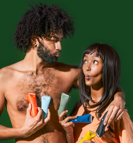 Two people holding colorful grooming trimmers, playfully posing against a green background.